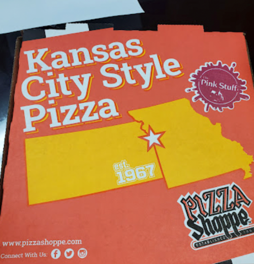 A pizza box featuring "Kansas City Style Pizza" with a star and the establishment year 1967.