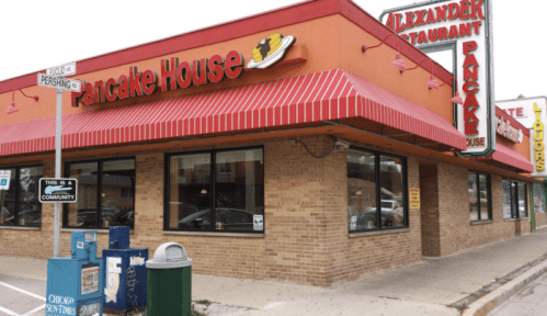 Exterior of Pancake House restaurant with a red awning, large windows, and a sign featuring a pancake graphic.