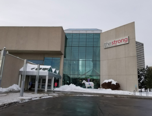 Exterior view of The Strong National Museum of Play, featuring a modern design and snow-covered ground.