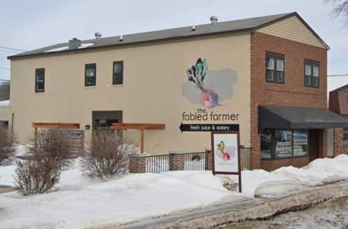 Exterior of "The Fabled Farmer" eatery, featuring a mural and snow-covered ground.