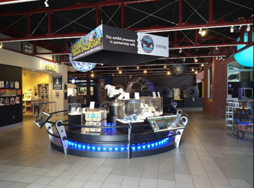 Exhibit space featuring displays about space exploration, with interactive elements and informational signage.