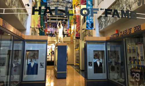 Interior view of a Hall of Fame, featuring displays, banners, and memorabilia celebrating inductees and their achievements.