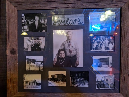 A framed collage of historical black-and-white photos, featuring people and buildings, labeled "Grilar's."