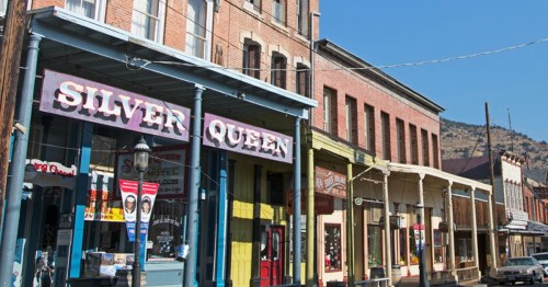 The historic brick facade of the Silver Queen Hotel along the main street of Virginia City, Nevada.