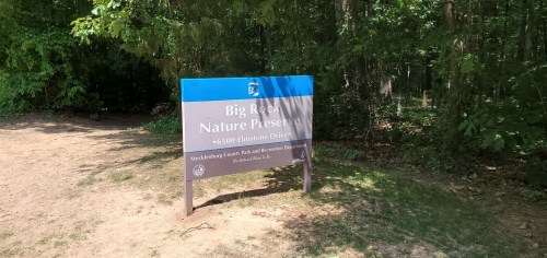 Sign for Big Rock Nature Preserve, located at 65100 Elmstone Drive, surrounded by trees and greenery.