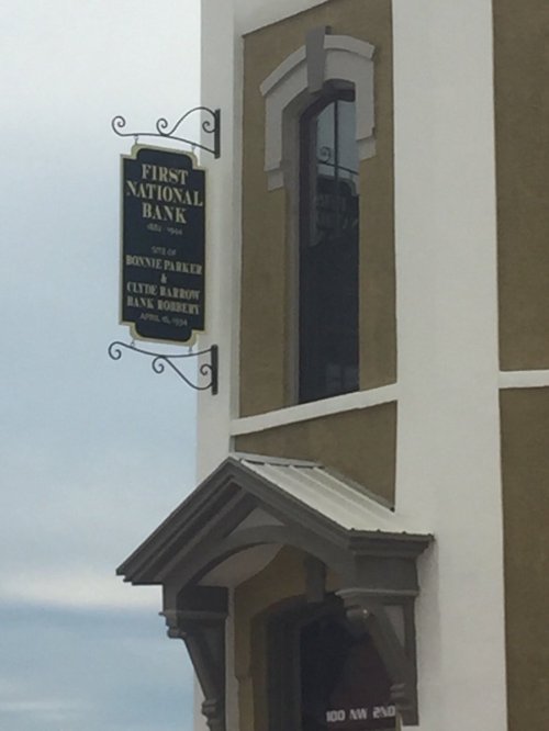 Sign for First National Bank, historic site of Bonnie Parker's robbery, with a date of April 6, 1934.