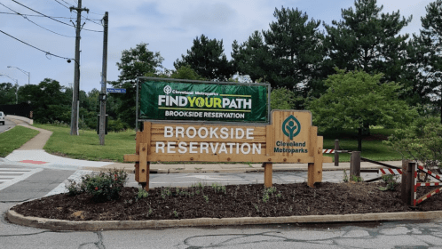 Sign for Brookside Reservation in Cleveland Metroparks, featuring "Find Your Path" banner and surrounding greenery.