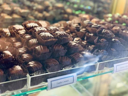 A display of assorted chocolate confections, including vanilla caramels, arranged in neat rows.