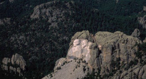 Aerial view of Mount Rushmore, featuring the carved faces of four U.S. presidents on a rocky mountain.