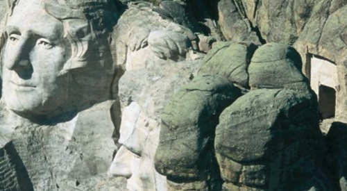 Aerial view of Mount Rushmore, featuring the carved faces of four U.S. presidents on a rocky mountain.
