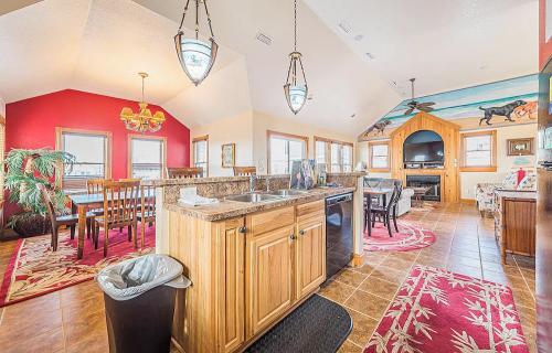 Bright, spacious kitchen and dining area with wooden cabinets, a large table, and cozy seating, featuring colorful decor.