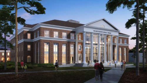 A modern brick library building with large columns, surrounded by trees and people walking in the evening light.