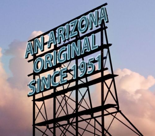 Sign reading "An Arizona Original Since 1951" against a backdrop of clouds.