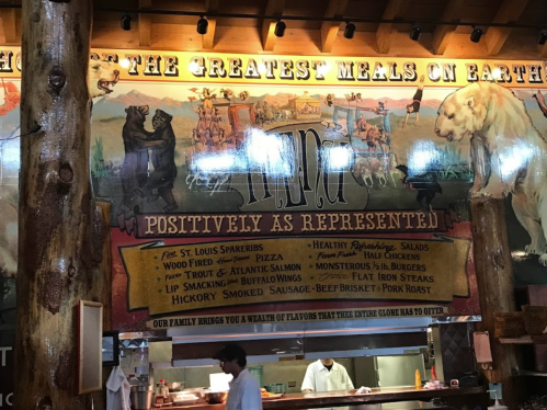 Colorful mural featuring a menu with various dishes like St. Louis spareribs, pizza, and smoked hickory meats.