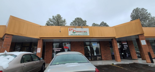 Exterior of a Mexican restaurant named "Las Gorditas," with snow on the ground and cars parked in front.