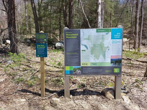 Signage at Monument Mountain trailhead, featuring maps and information about the area and activities available.