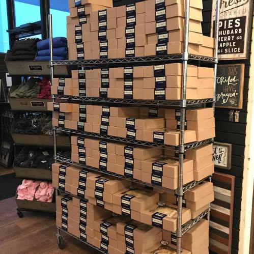A metal shelving unit filled with neatly stacked brown boxes, organized in rows.