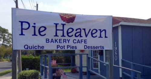 Sign for "Pie Heaven Bakery Cafe" featuring quiche, pot pies, and desserts, with a pie graphic above the text.