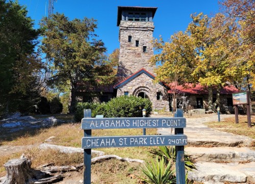 Stone tower at Cheaha State Park, Alabama's highest point, with a sign indicating the elevation of 2,407 feet.