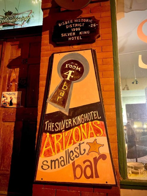 Sign for the Silver King Hotel, featuring "Arizona's smallest bar" in the Bisbee Historic District.