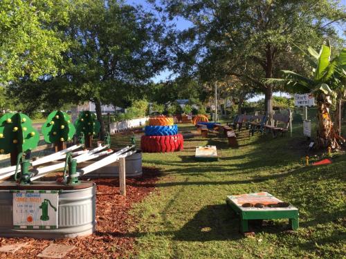 A colorful outdoor play area with tire structures, benches, and greenery, inviting children to explore and play.