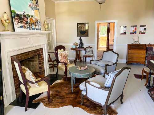 Cozy living room with vintage furniture, a fireplace, and artwork, featuring a mix of textures and warm colors.