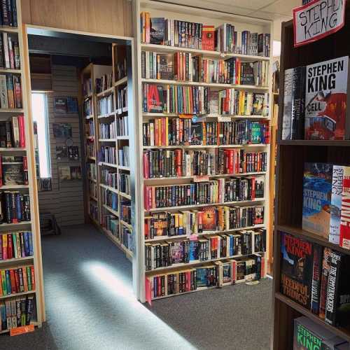 A cozy bookstore interior with shelves filled with various books, including a prominent display of Stephen King titles.