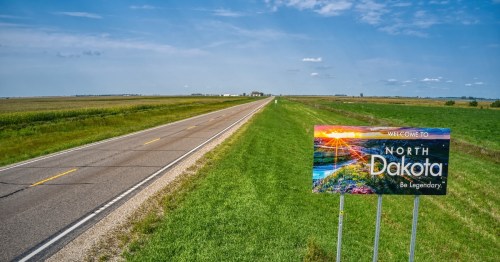 Welcome sign for North Dakota featuring a scenic landscape and the slogan "Be Legendary."