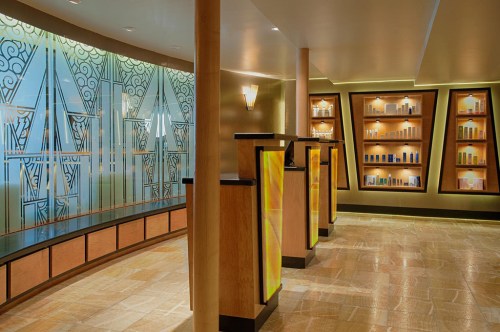 A stylish interior featuring elegant decor, display shelves, and a reception area with warm lighting and geometric patterns.