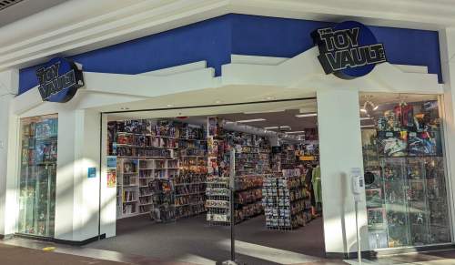 Storefront of "The Toy Vault," showcasing shelves filled with toys and collectibles inside.