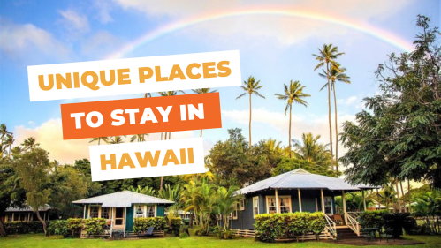 A scenic view of tropical cottages under a rainbow, with palm trees and lush greenery, promoting unique stays in Hawaii.