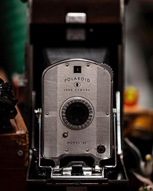 Close-up of a vintage Polaroid Land Camera Model 95, showcasing its silver body and classic design.