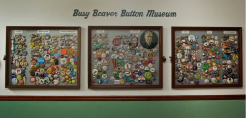Three display boards filled with colorful buttons at the Busy Beaver Button Museum, showcasing various designs and themes.