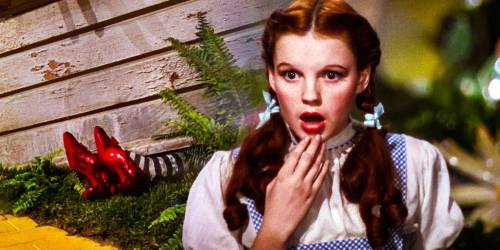 A surprised girl with red hair and pigtails, wearing a blue and white dress, stands near a pair of red shoes.
