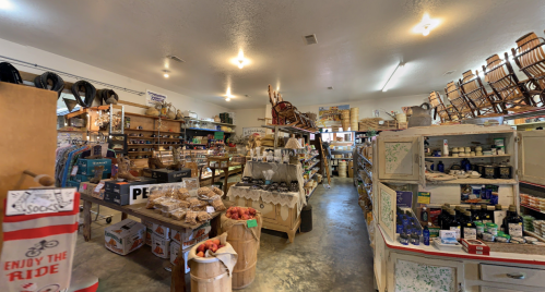 A cozy store interior filled with shelves of goods, baskets, and rustic decor, creating a warm, inviting atmosphere.