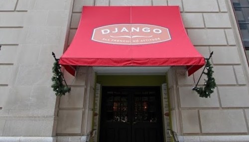 Red awning with "DJANGO" sign above a restaurant entrance, decorated with green garlands.