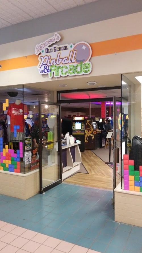 Entrance to Ottawa's Old School Pinball & Arcade, featuring colorful decor and arcade games visible inside.