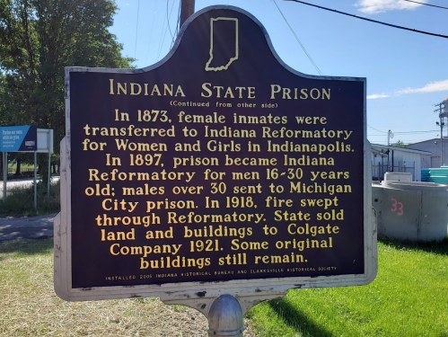 Historical marker about Indiana State Prison, detailing its history and changes from 1873 to 1921.