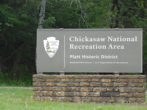 Sign for Chickasaw National Recreation Area, Platt Historic District, with National Park Service logo.