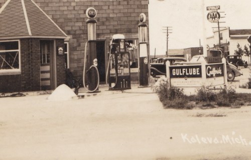 Historic gas station in Kaleva, Michigan, featuring vintage pumps and a sign for Gulf lubricants.