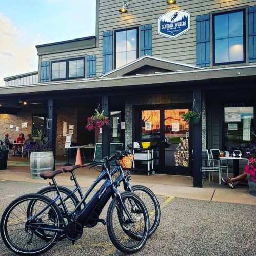 Bicycles parked outside a rustic building with a sign for "Cathedral Mountain" and outdoor seating.
