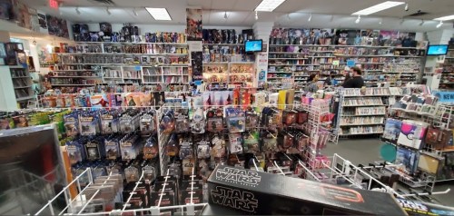 A vibrant toy and collectibles store filled with shelves of action figures, DVDs, and memorabilia.