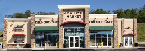 Exterior of Mid-Atlantic Market featuring a deli, grocery, and café, with stone accents and large windows.