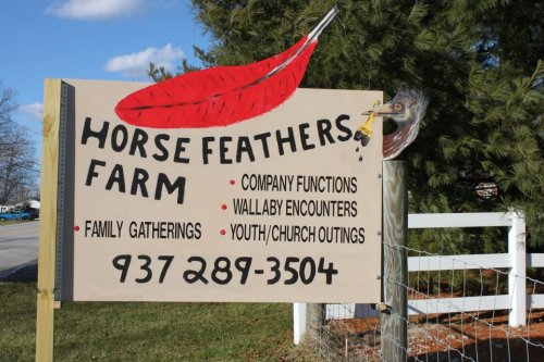 Sign for Horse Feathers Farm, listing services for family gatherings, company functions, wallaby encounters, and youth outings.
