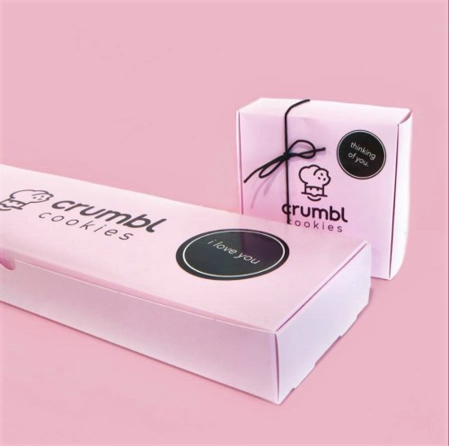 Two pink Crumbl Cookies boxes, one large with "I love you" and a smaller one with "Thinking of you" labels.