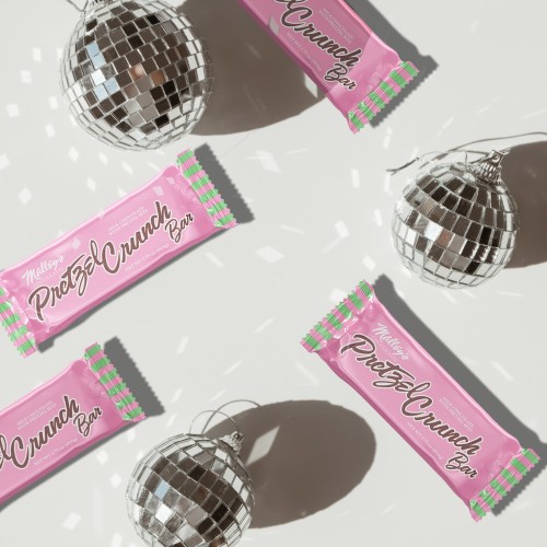 Flat lay of Milky Way Pretzel Crunch Bars and disco balls on a light background.