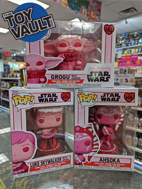 Three Star Wars Funko Pop figures in pink packaging: Grogu with cookies, Luke Skywalker, and Ahsoka.