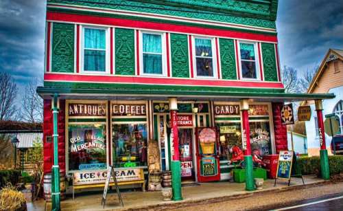 Colorful vintage storefront featuring antiques, coffee, candy, and ice cream, with a welcoming "Open" sign.