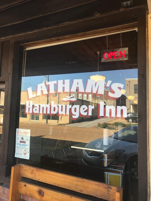 Sign on a restaurant window reads "Latham's Hamburger Inn" with an "Open" sign above it.