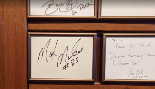 A framed display featuring signatures, including one from "Mark McGwire #85" and a thank-you note to "Keenan."